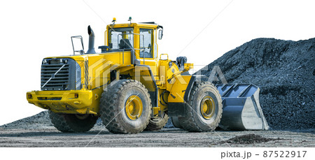 Yellow wheeled loader on front of pile of gravel isolated on white background Yellow wheeled loader on front of pile of gravel isolated on white background 87522917