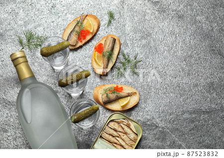 Flat lay composition with cold Russian vodka on grey table. Space for text 87523832