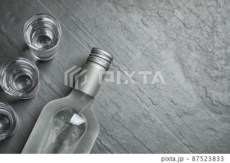 Cold Russian vodka on black table, flat lay. Space for text Cold Russian vodka on black table, flat lay. Space for text 87523833