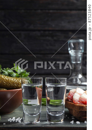 Cold Russian vodka with snacks on table Cold Russian vodka with snacks on table 87523840