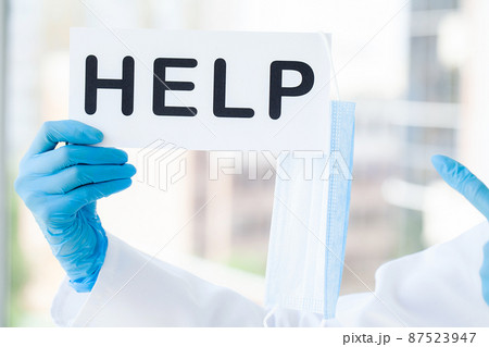 Woman doctor holds a form with the text help Woman doctor holds a form with the text help 87523947