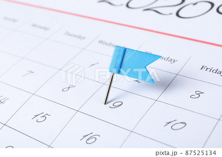Calendar page marked with drawing pin, closeup Calendar page marked with drawing pin, closeup 87525134