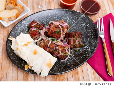 Grilled pork meat shashlik with marinated onion Grilled pork meat shashlik with marinated onion 87534744