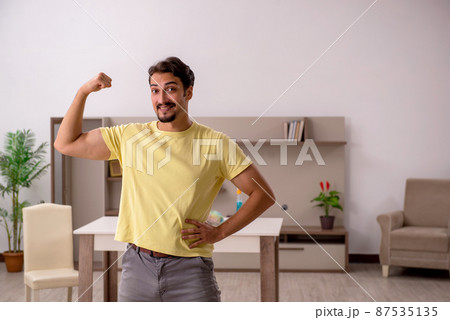 Young man doing housework at home Young man doing housework at home 87535135