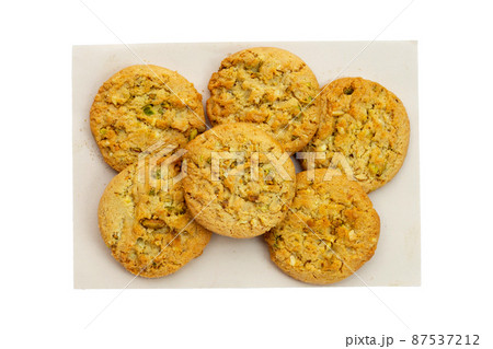 Pistachio and almond cookies on brown paper on white background. Pistachio and almond cookies on brown paper on white background. 87537212