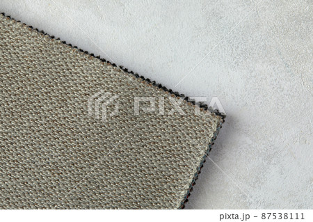 abstract texture of rough cotton fabric or canvas with drawing from fibers a cross crosswise for backgrounds of gray color 87538111