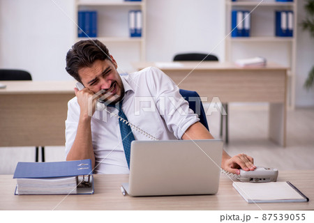 Young male employee working in the office Young male employee working in the office 87539055