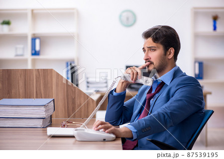 Young male employee working in the office 87539195
