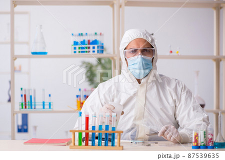 Young male chemist working at the lab during pandemic Young male chemist working at the lab during pandemic 87539635