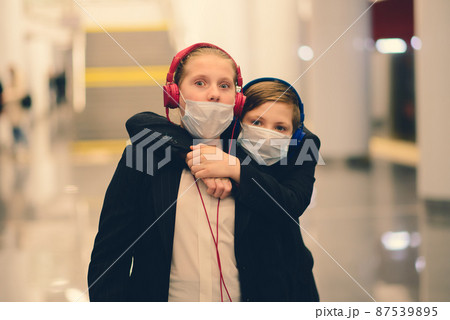 Children with face mask going back to school after covid-19 quarantine and lockdown. 87539895