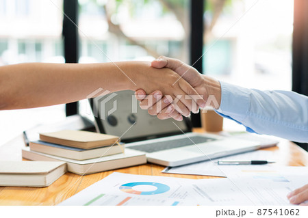 Business negotiation concept the estate representatives shaking hand each other to agree with the deal of land 87541062