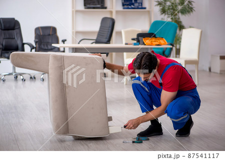 Young male carpenter working at workshop 87541117