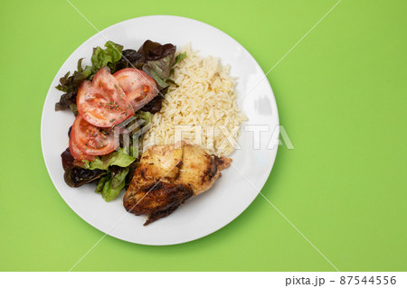 grilled chicken with boiled rice and fresh salad 87544556