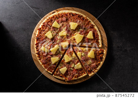 Hawaiian pizza with pineapple,ham and cheese 87545272