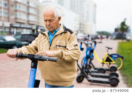 Senior man riding electric scooter Senior man riding electric scooter 87549006