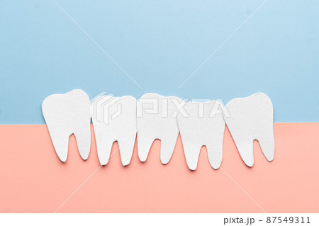 Crowding tooth cartoon made from paper. Problems resulting from dental crowding include gum disease, trouble chewing, toothache or jaw pain. Crowding tooth cartoon made from paper. Problems resulting from dental crowding include gum disease, trouble chewing, toothache or jaw pain. 87549311