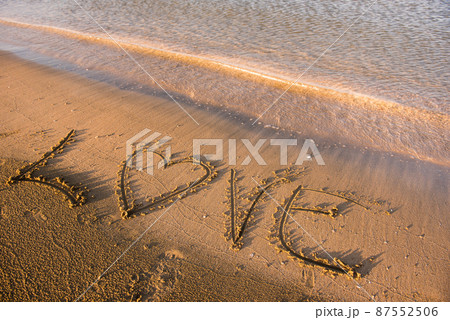 Love word written in sand 87552506