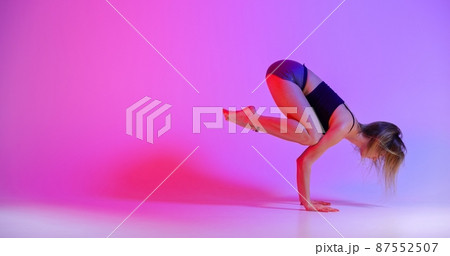 Blonde woman doing yoga in studio close up 87552507