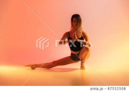 Blonde woman doing yoga in studio close up 87552508