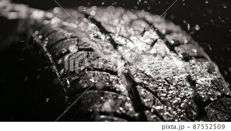 Clean car tires against dark background closeup 87552509