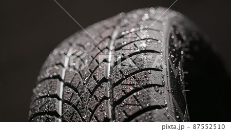 Clean car tires against dark background closeup 87552510