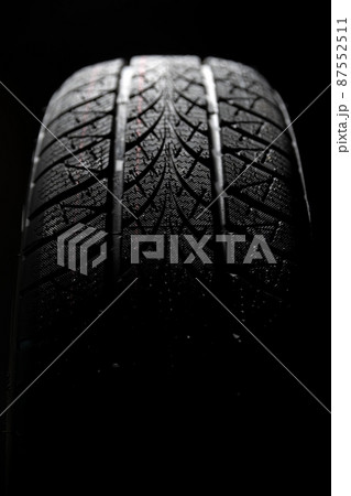 Clean car tires against dark background closeup 87552511