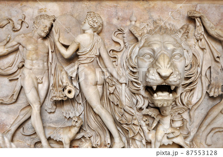 Bas-relief and sculpture of ancient Roman Gods and a lion head 87553128