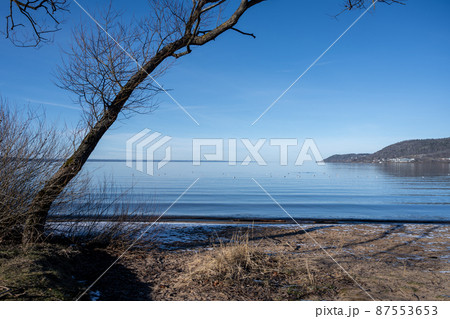 A beautiful lake view in the morning. A mist over the blue lake A beautiful lake view in the morning. A mist over the blue lake 87553653