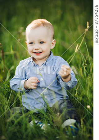Portrait of stylish blonde little boy sitting in Portrait of stylish blonde little boy sitting in 87554256