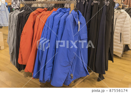 men's winter jackets on hangers in the store 87556174