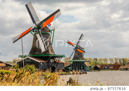 Colorful Dutch Windmills at the river Zaan, Zaanse Schans, Zaandam, The Netherlands Colorful Dutch Windmills at the river Zaan, Zaanse Schans, Zaandam, The Netherlands 87557616
