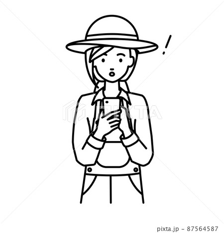 立ってスマートフォンを操作して何かに気づいて驚いた農家の女性 87564587