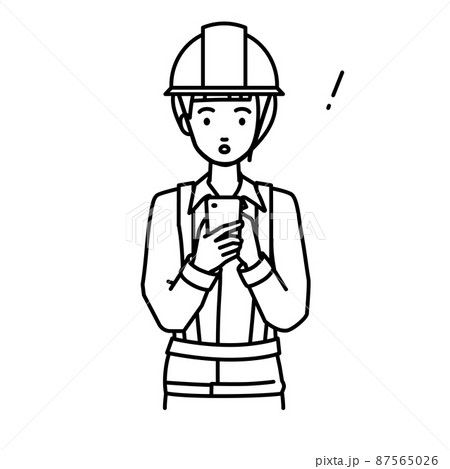 立ってスマートフォンを操作して何かに気づいて驚いた工事現場の女性 87565026