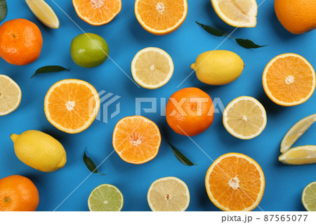 Flat lay composition with tangerines and different citrus fruits on blue background Flat lay composition with tangerines and different citrus fruits on blue background 87565077
