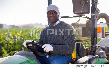 African-american man driving tractor on plantation African-american man driving tractor on plantation 87565130