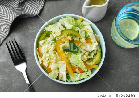 Fresh cabbage salad with bell pepper served on grey table, flat lay 87565268