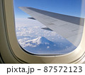 Top view fuji mountain landmark of Japan and aircraft wing from a window seat 87572123
