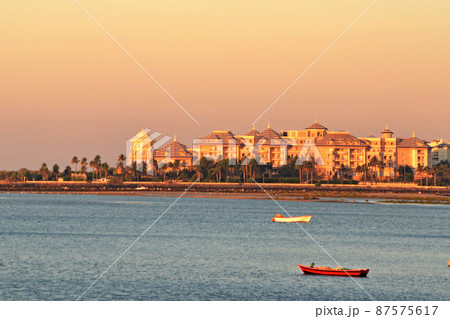 Beautiful sunset on the beach on a summer morning with the boats in the foreground Beautiful sunset on the beach on a summer morning with the boats in the foreground 87575617