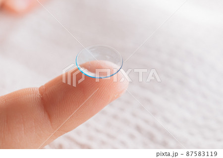 close-up. contact lens on a child's finger.  87583119