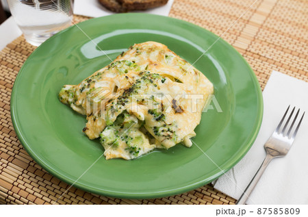 wholesome breakfast. omelet with broccoli on green plate wholesome breakfast. omelet with broccoli on green plate 87585809