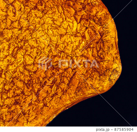 Natural amber texture. Multicolored background for advertising and banners. Vintage fossilized resin as a background. Red amber amber background. Close-up amber Natural amber texture. Multicolored background for advertising and banners. Vintage fossilized resin as a background. Red amber amber background. Close-up amber 87585904