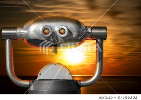 Coin Operated Binoculars with a Beautiful Sunset Over the Sea Coin Operated Binoculars with a Beautiful Sunset Over the Sea 87586302
