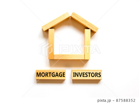 Mortgage investors symbol. Concept words 'Mortgage investors' on wooden blocks near miniature wooden house. Beautiful white background. Business, mortgage investors concept. 87588352