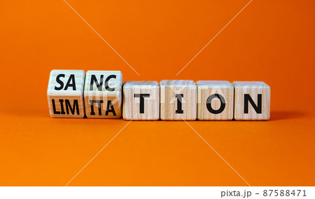 Sanction and limitation symbol. Turned wooden cubes and changed the word limitation to sanction. Beautiful orange table, orange background, copy space. Business, sanction and limitation concept. Sanction and limitation symbol. Turned wooden cubes and changed the word limitation to sanction. Beautiful orange table, orange background, copy space. Business, sanction and limitation concept. 87588471