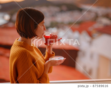 Woman drinking turkish tea from traditional turkish teacup 87589616