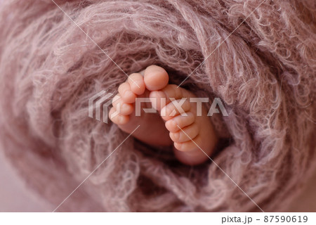 Small beautiful legs of a newborn baby in the first days of life 87590619