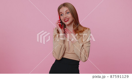 Businesswoman girl having pleasant mobile phone conversation using smartphone telling good news 87591129