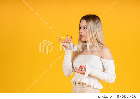 young girl sending audio message with smartphone to friend 87592716