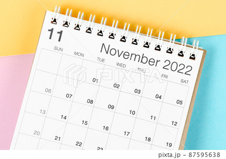 November 2022 desk calendar on multicolored background. 87595638
