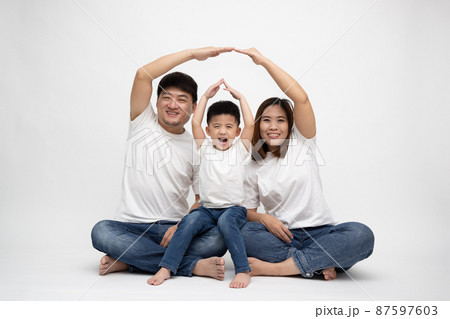 Asian family smiling and playing house by hand on isolated white background. Family with new home concept 87597603
